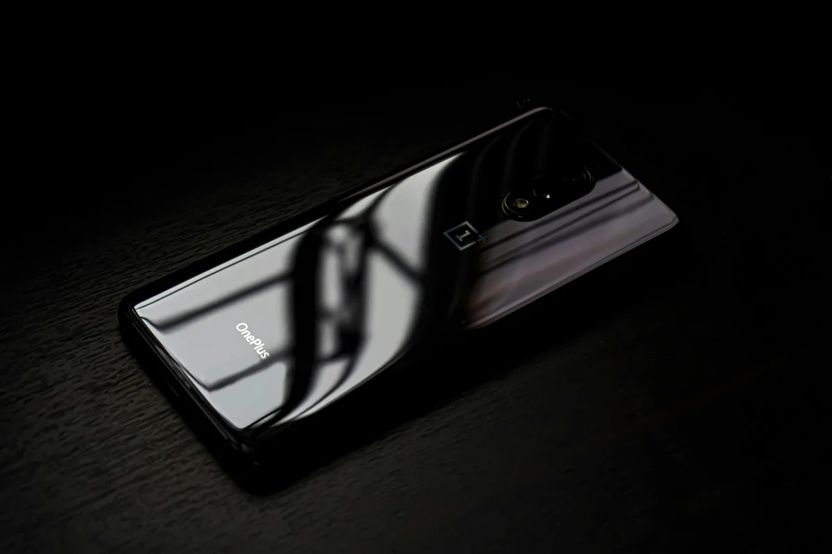 black android smartphone on brown wooden table - smartphone technology - box tv android