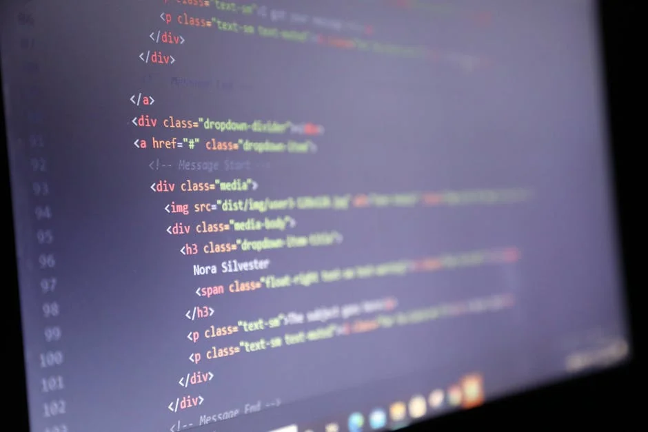 Illuminated HTML code displayed on a computer screen, close-up view. - iptv code 12 months