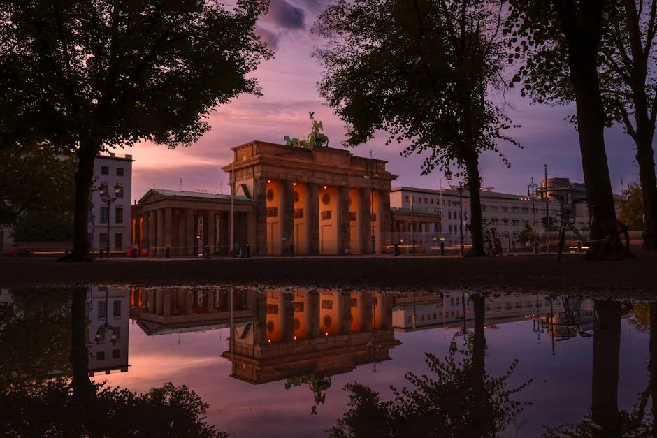 Captivating sunrise view of Brandenburg Gate with stunning reflection in Berlin, Germany. - iptv deutschland