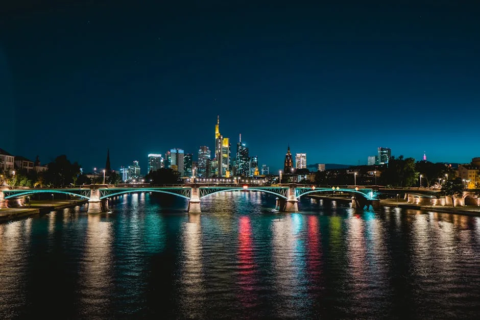 Stunning night view of Frankfurt's skyline and reflections on the river with illuminated bridge. - iptv deutschland