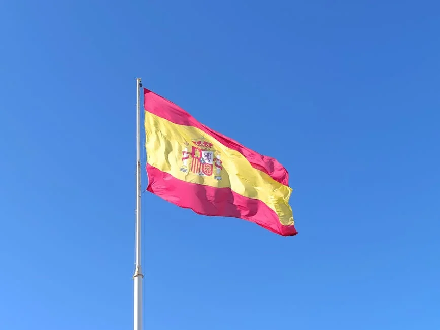 The Spanish national flag waves against a clear blue sky, symbolizing national pride. - iptv espaa