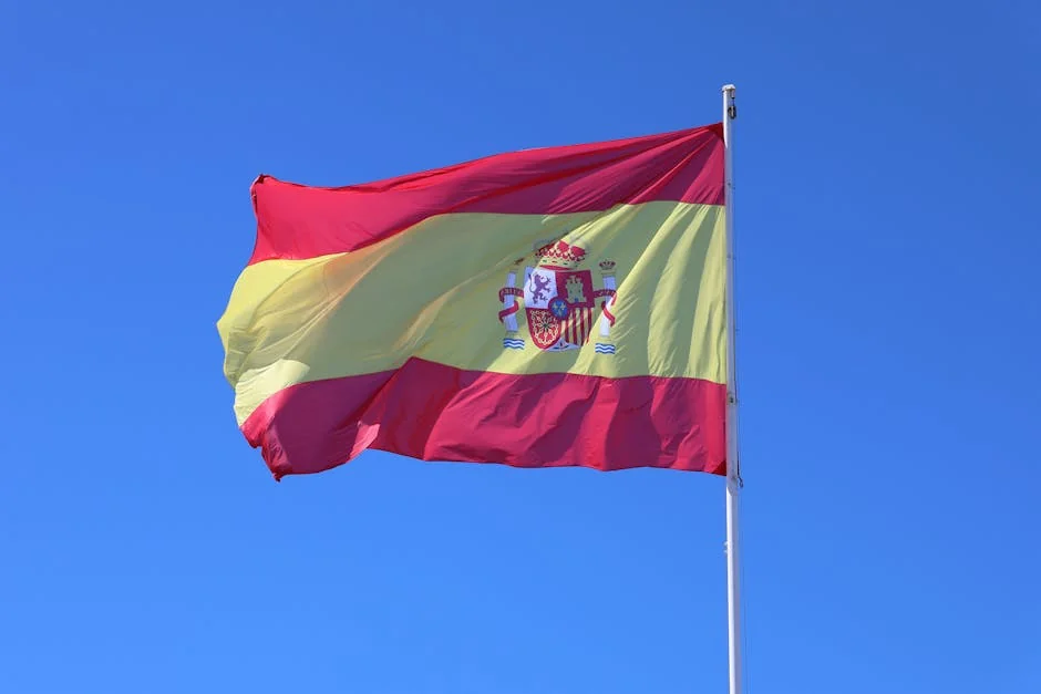 Vibrant Spanish flag waving against a clear blue sky in Cádiz, Andalucía, España. - iptv espaa