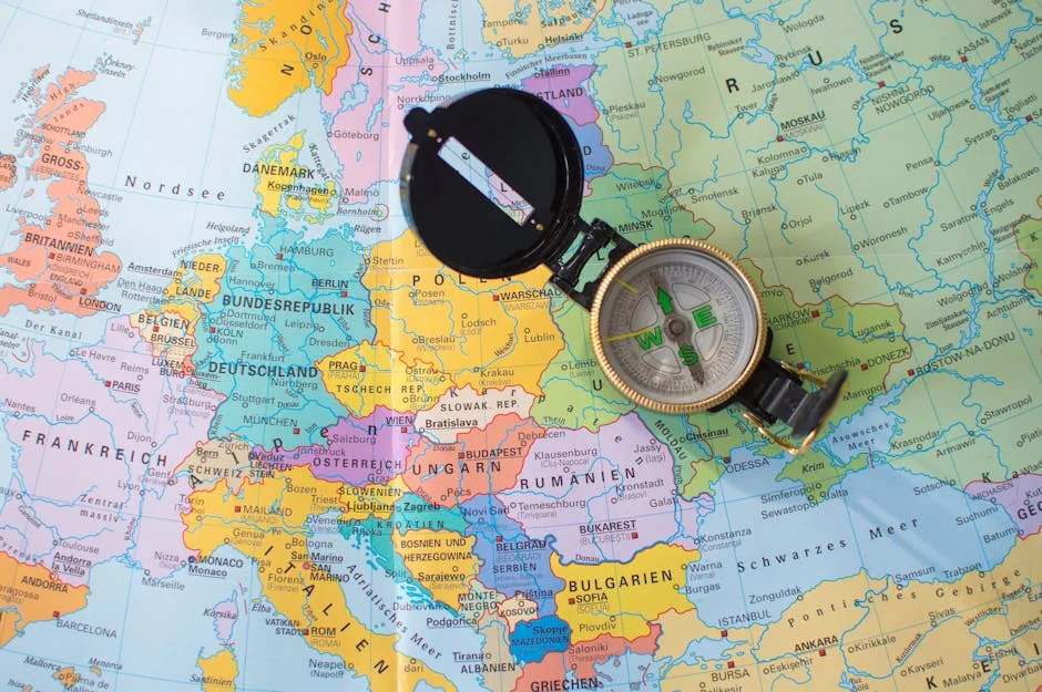 A flat lay image of a compass on a map of Europe, symbolizing travel and direction planning. - iptv europe