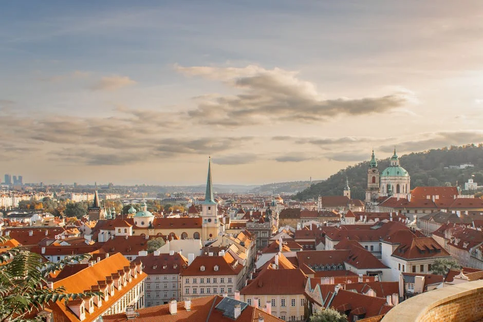 Captivating view of Prague's historic skyline with red rooftops and iconic architecture under a warm sunset. - iptv europe