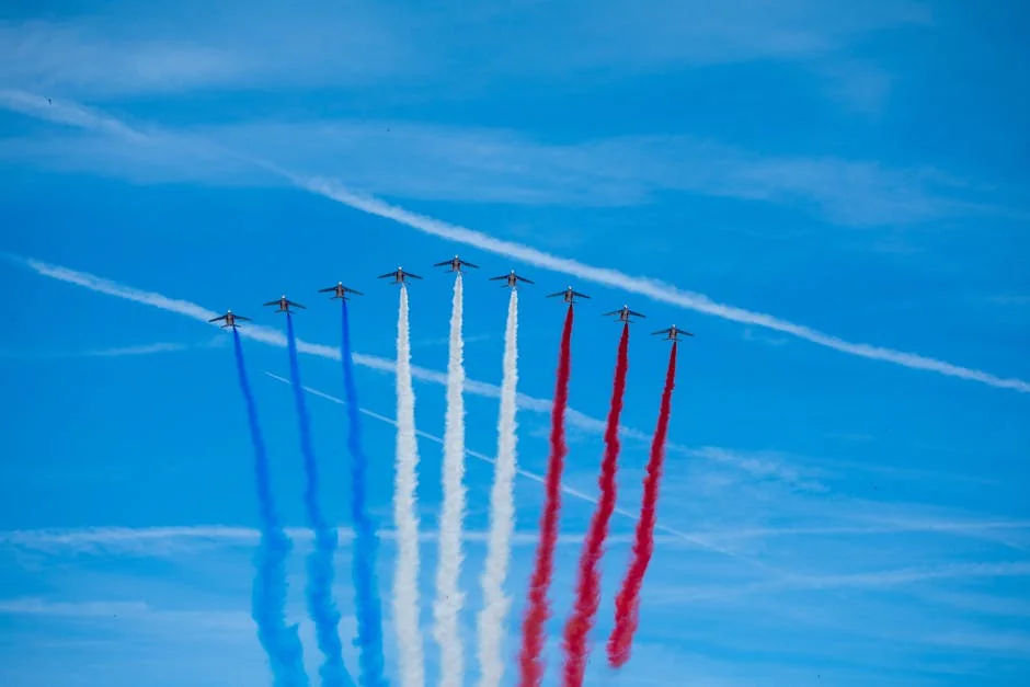 Patrouille de France jets performing an aerobatic display with colored smoke trails over Paris. - iptv france