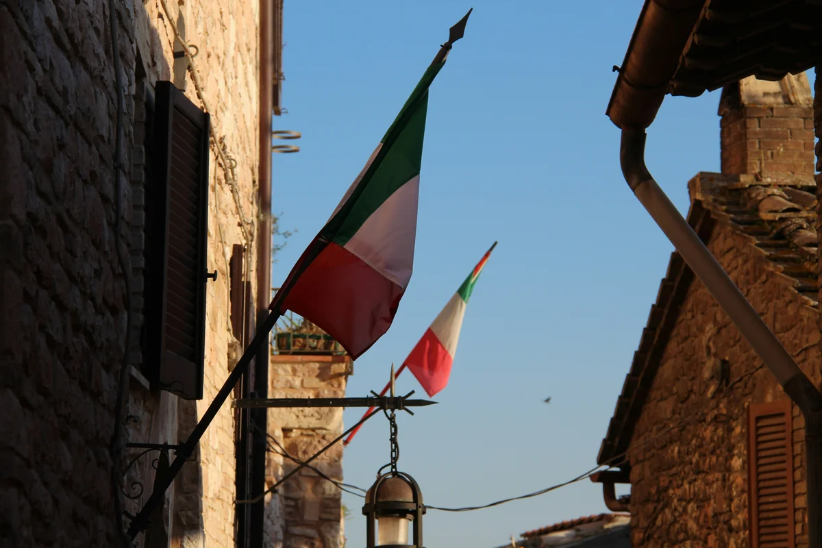 a flag flying in the wind next to a building - iptv italia