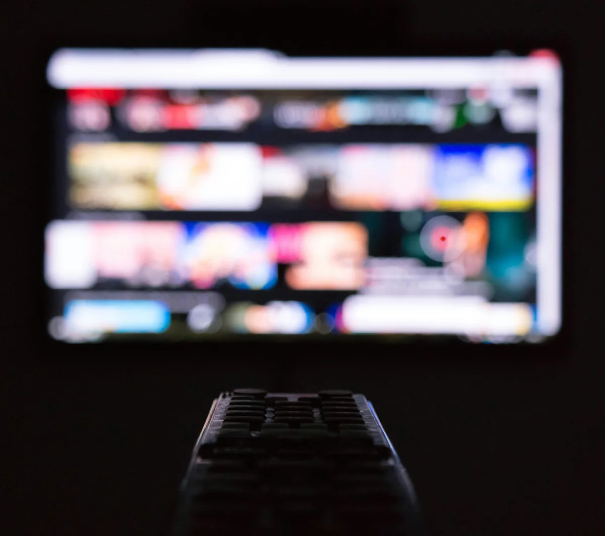 a remote control sitting in front of a television - iptv list