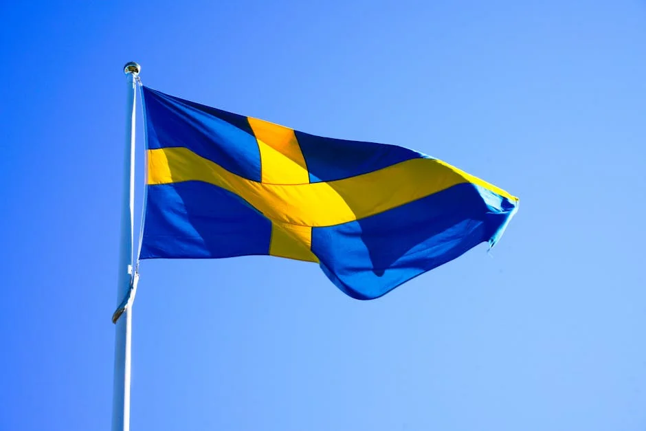 Bright Swedish flag waving on a clear day with blue sky. - iptv livego swedish