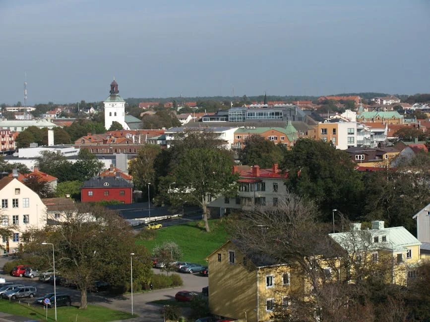 Aerial view of a Swedish townscape featuring a historic church tower amid colorful buildings. - iptv livego swedish