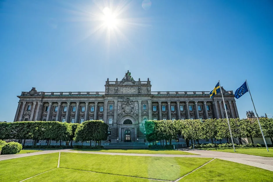 Front view of the Riksdag building with Swedish and EU flags on a sunny day. - iptv livego swedish
