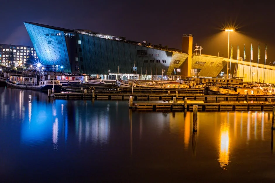 Night view of NEMO Science Museum and harbor reflections in Amsterdam. - iptv netherlands