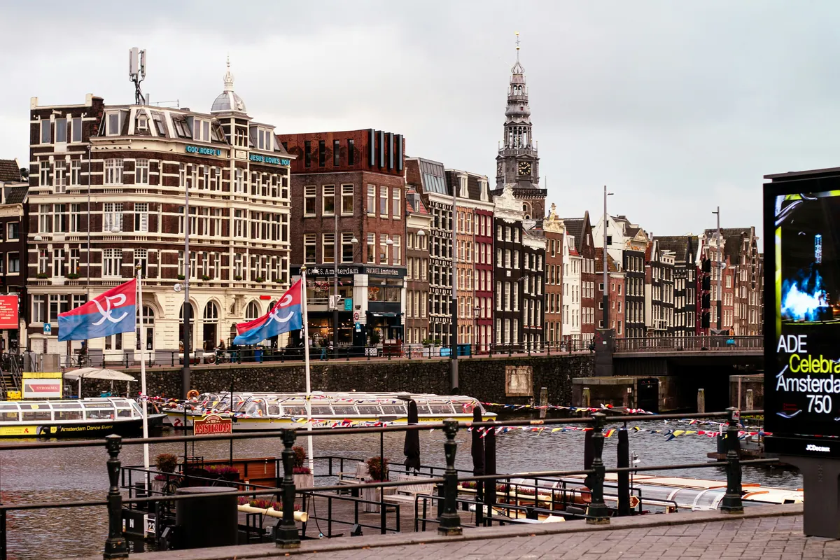 Canal with boats and buildings in amsterdam - iptv netherlands