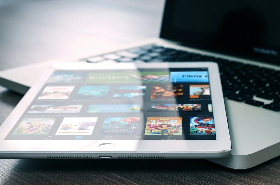 Tablet displaying streaming services on a laptop, illustrating digital entertainment setup. - iptv service