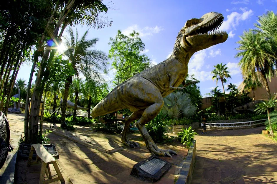 Life-sized Tyrannosaurus Rex statue in a lush tropical park, perfect for outdoor dinosaur exhibits. - trex iptv